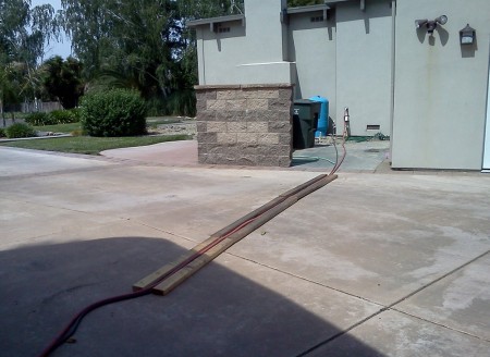 Running the power cord and 3/4 inch 'sewer hose' across the driveway. 