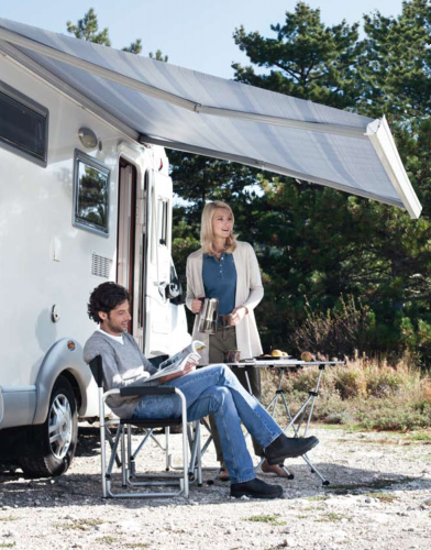 Camping couple under RV Awning